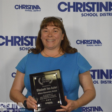 Photo of Elizabeth Van Aulen Teacher of the Year Wilson ES holding award